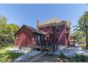 Rear view of the renovated home, highlighting the deck and landscaping at 404 N State St, Greenfield, IN 46140