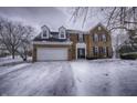 Two story brick home with attached garage, snowy front yard at 415 Calamus Ct, Indianapolis, IN 46239