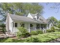 Quaint two-story home boasting a charming covered porch and well-manicured landscaping at 4462 S Morgantown Rd, Greenwood, IN 46143