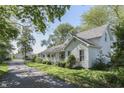 Inviting two-story house with a covered front porch, set on a tree-lined lot at 4462 S Morgantown Rd, Greenwood, IN 46143