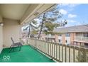 Private balcony with green turf and view of other buildings at 581 W Hunters Dr # Apt D, Carmel, IN 46032