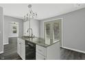 Modern kitchen island with granite countertops and stainless steel appliances at 7077 E Mulberry St, Gwynneville, IN 46144