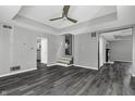 Spacious living room with gray walls and dark gray wood-look floors at 7077 E Mulberry St, Gwynneville, IN 46144