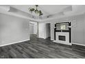 Living room featuring a fireplace and ceiling fan at 7077 E Mulberry St, Gwynneville, IN 46144