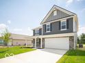 Inviting two-story home featuring gray siding, a covered front porch, green lawn, and an attached garage at 7541 Big Bend Blvd, Camby, IN 46113