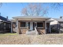 Brick house with front porch and steps, autumn leaves on lawn at 836 S Tremont St, Indianapolis, IN 46221