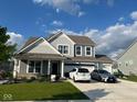 Charming two-story home boasts a three car garage, and a beautifully landscaped front yard, creating curb appeal at 9426 Orchard Cove Dr, Indianapolis, IN 46239