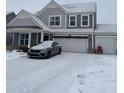 Gray two-story house with a snowy front yard and attached garage at 9426 Orchard Cove Dr, Indianapolis, IN 46239