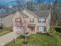 Charming two-story home featuring brick accents, red shutters, well-manicured lawn, and a 'For Sale' sign on the front yard at 10391 Butler Dr, Brownsburg, IN 46112