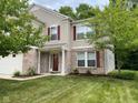 Two-story house with brick and siding, red shutters, and a well-manicured lawn at 10391 Butler Dr, Brownsburg, IN 46112