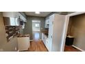 Modern kitchen with white cabinets, wood countertops, and stainless steel appliances at 11 Eastridge Dr, Greenwood, IN 46143