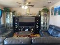 Living room boasts leather sofas, large TV, and wooden coffee table at 116 Kenova Dr, Indianapolis, IN 46227
