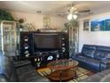 Living room with leather sofas, large TV, and wooden coffee table at 116 Kenova Dr, Indianapolis, IN 46227