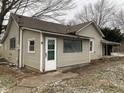 Tan house with green door and small window at 12625 Strawtown Ave, Noblesville, IN 46060