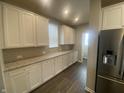 White kitchen cabinets, granite countertops, and stainless steel appliances at 17389 Dallington St, Westfield, IN 46074