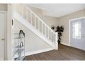 Bright entryway with hardwood floors, staircase, and a modern door at 2215 Brookside Ave, Indianapolis, IN 46218