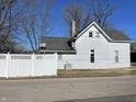 White house with a gray roof and a fenced backyard at 30 N Muessing St, Indianapolis, IN 46229
