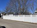 White vinyl fence with a lattice top along the property line at 30 N Muessing St, Indianapolis, IN 46229