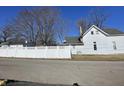 View of the white vinyl fence and part of the house at 30 N Muessing St, Indianapolis, IN 46229