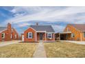 Charming brick home with a cozy porch, well-maintained landscaping, and freshly laid mulch at 3017 Sherman St, Anderson, IN 46016