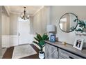 Bright and spacious entryway with a wooden console table and large mirror at 3572 Blenheim Pl, Westfield, IN 46074