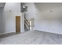 Spacious living room showcasing neutral tones, soaring ceilings, updated flooring, and an open staircase at 368 Seabreeze Cir, Avon, IN 46123