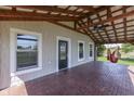 Spacious covered porch with brick flooring, ceiling fan, and cozy seating, ideal for outdoor relaxation at 5750 W 300 N Rd, Bargersville, IN 46106