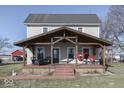 Two-story farmhouse with a large covered porch at 5750 W 300 N Rd, Bargersville, IN 46106
