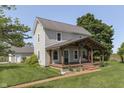 Two-story home with covered porch, decorative columns, and a brick walkway enhances the curb appeal at 5750 W 300 N Rd, Bargersville, IN 46106