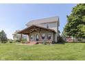 Inviting two-story home with a cozy covered porch featuring hanging chairs, perfect for enjoying the outdoors at 5750 W 300 N Rd, Bargersville, IN 46106