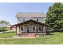 Charming two-story home with a covered front porch and mature trees offering a relaxing outdoor space at 5750 W 300 N Rd, Bargersville, IN 46106