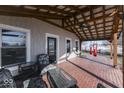 Spacious covered porch with brick flooring and outdoor seating at 5750 W 300 N Rd, Bargersville, IN 46106
