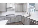 Modern kitchen with gray cabinets, stainless steel appliances, and an island at 7300 Legends Way, Whitestown, IN 46052