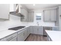 Modern kitchen with gray cabinets, stainless steel appliances, and an island at 7300 Legends Way, Whitestown, IN 46052