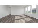 Bright, spacious living room with hard surface flooring and ample natural light from multiple windows at 7300 Legends Way, Whitestown, IN 46052