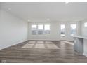 Bright, spacious living room with hard surface flooring and ample natural light from multiple windows at 7300 Legends Way, Whitestown, IN 46052
