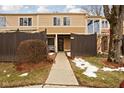 Townhouse exterior with snow on the ground and wooden fence at 741 Ironwood Dr, Avon, IN 46123