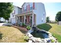 Two-story house with a pond and landscaping in the front yard at 833 Palisades Ct, Greenwood, IN 46143