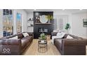 Open living space with brown leather sofas and a modern fireplace at 923 E Pleasant Run Pkwy S Dr, Indianapolis, IN 46203