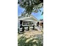 Renovated bungalow with a gray exterior and a spacious front porch at 929 N Bancroft St, Indianapolis, IN 46201