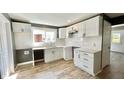 Modern white kitchen with stainless steel appliances and marble countertops at 929 N Bancroft St, Indianapolis, IN 46201