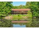 Beautiful reflection of the rustic house in a serene pond surrounded by lush greenery at 9600 N 500 E, Pendleton, IN 46064