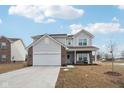 Two story home with gray siding, brick accents, and a two-car garage at 1075 Galaxy Ln, Danville, IN 46122