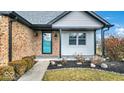 Inviting front entry with teal door, brick facade, and landscaping at 11726 E 75Th St, Indianapolis, IN 46236
