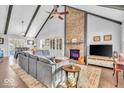 Spacious living area featuring a brick fireplace, vaulted ceiling, and comfy seating at 11726 E 75Th St, Indianapolis, IN 46236