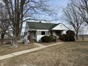 Inviting two-story home featuring a covered porch and manicured front yard at 1282 W State Road 252, Trafalgar, IN 46181