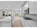 Modern kitchen with stainless steel appliances, sleek countertops, a kitchen island, and ample natural light at 16956 Cattle Hollow Ln, Noblesville, IN 46060