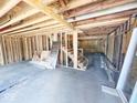 Unfinished basement with exposed framing and stairs at 2913 Macpherson Ave, Indianapolis, IN 46205