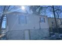 Rear view of house with partial basement exposure at 302 E Cowing Dr, Muncie, IN 47303
