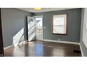 Bright living room with hardwood floors and gray walls at 302 E Cowing Dr, Muncie, IN 47303